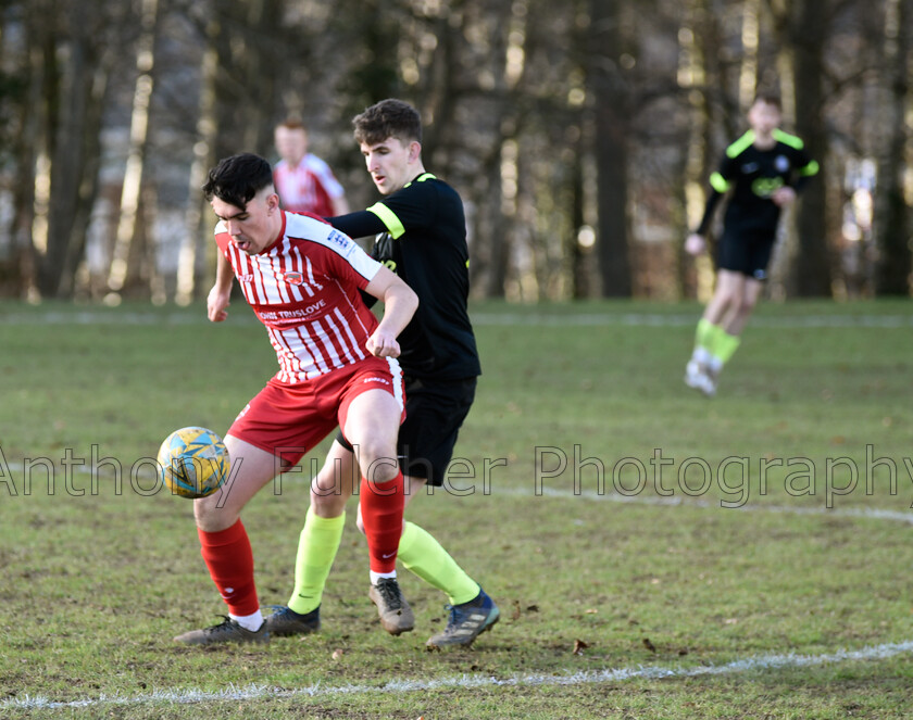 U21s-football-(2) 
 A player holding the other back whilst trying to get the ball under control, 
 Keywords: football, soccer, youth, u21s, challenge, final, muddy,