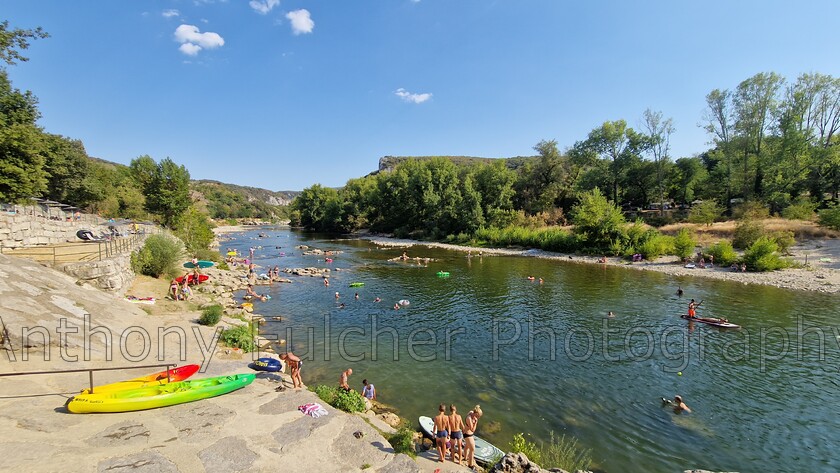 Ardeche river 
 Shot of the Ardeche river in the summer, kayakers and swimmers alike. 
 Keywords: river, vallon, pont d'arc, france, kayaking, canoeing, swimming, summer,