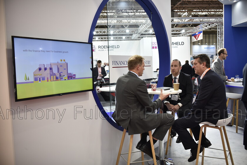 talking business 
 A business meeting taking place at an exhibition at the NEC Birmingham UK 
 Keywords: exhibition, meeting, business,